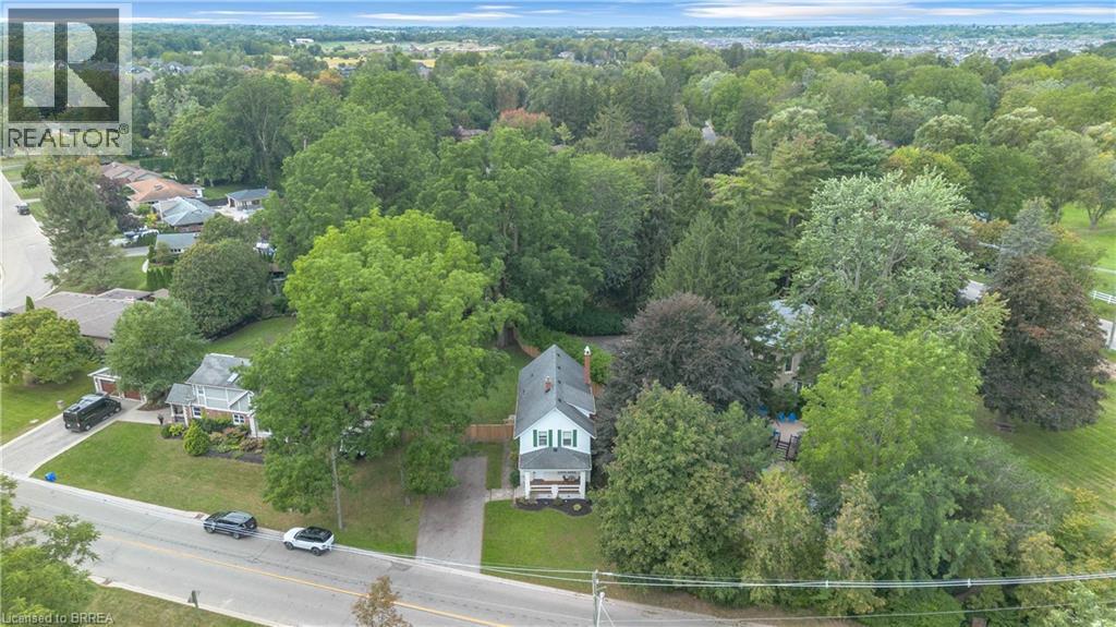 Two-story residence with a white exterior and light green shutters - 11 Tutela Heights Road, Brantford, ON