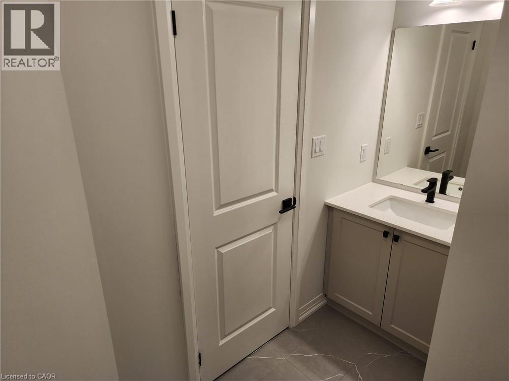 White shaker-style vanity with a white countertop and integrated sink - 155 Equestrian Way Unit# 152, Cambridge, ON