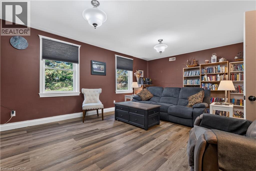 Spacious room featuring wood-finish flooring and two distinct built-in bookshelves - 42841 Highway 3, Wainfleet, ON