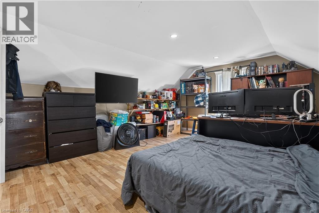 Spacious room featuring sloped ceilings, recessed lighting, wood-finish flooring, and a window - 42841 Highway 3, Wainfleet, ON