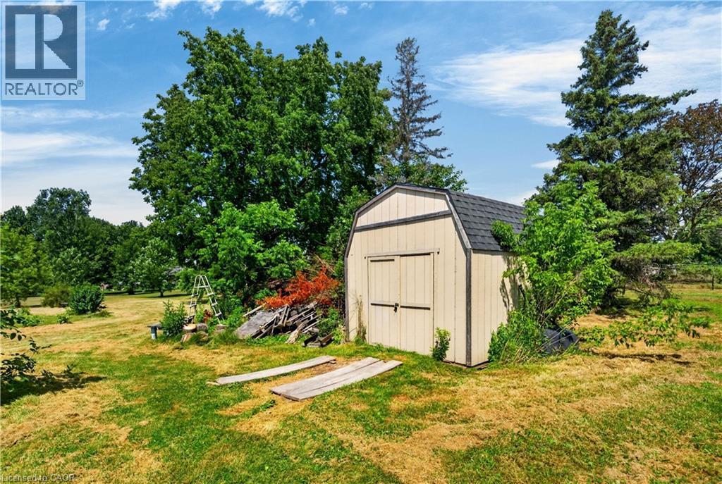 Spacious backyard featuring a utility shed with a gambrel roof and double doors - 42841 Highway 3, Wainfleet, ON