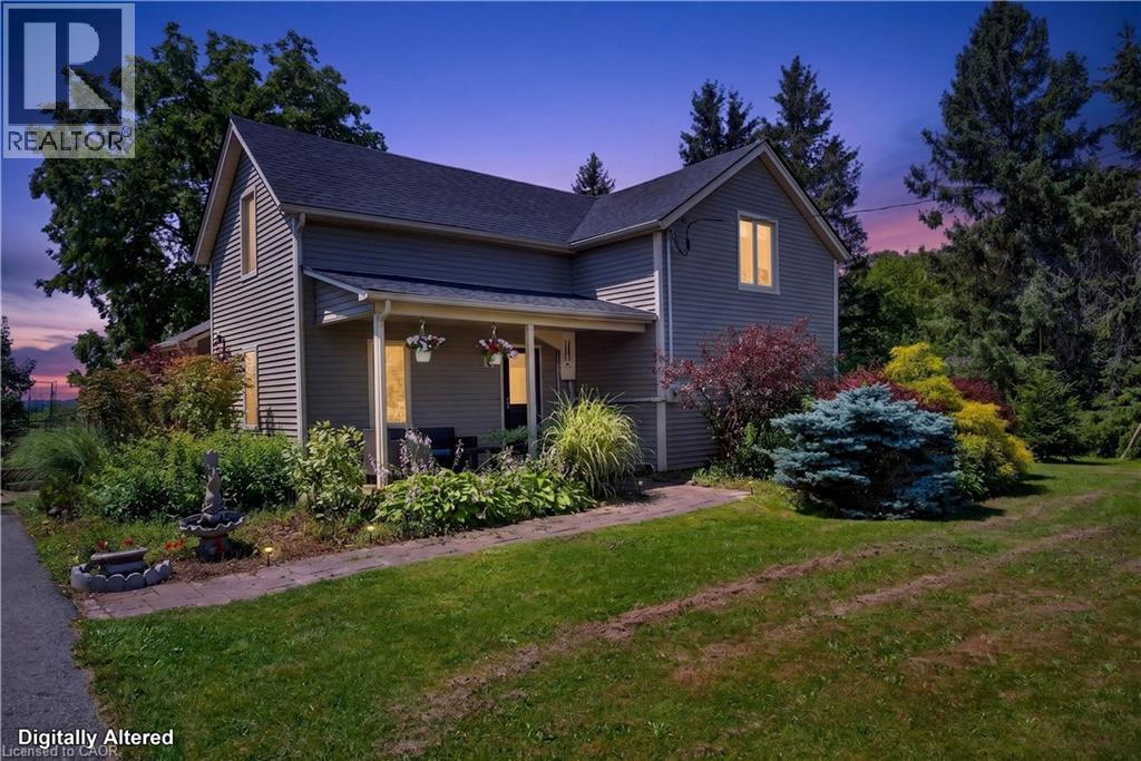 Siding exterior with a covered front porch and mature landscaping - 42841 Highway 3, Wainfleet, ON