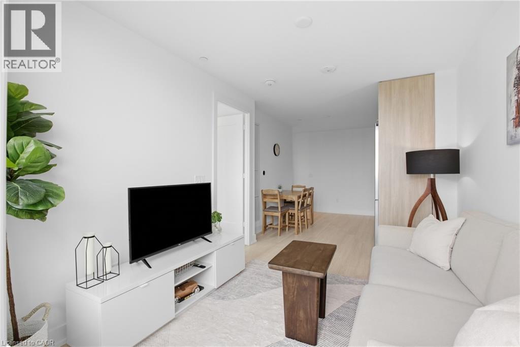 Recessed lighting throughout, light wood-finish flooring, white walls, and a built-in media console - 60 Central Park Roadway Unit# 2010, Etobicoke, ON