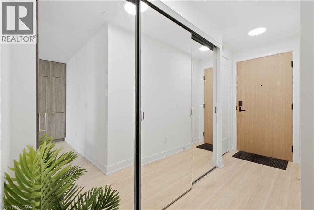 Light wood-finish flooring, recessed lighting, mirrored closet doors, and a wood-finish entry door - 60 Central Park Roadway Unit# 2010, Etobicoke, ON
