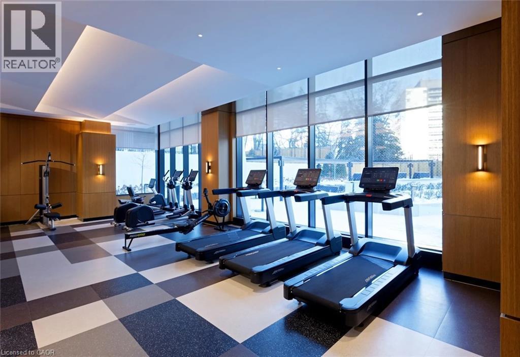 Fitness center with full-height windows, recessed lighting, wood-finish wall panels, and checkerboard floor tiling - 60 Central Park Roadway Unit# 2010, Etobicoke, ON
