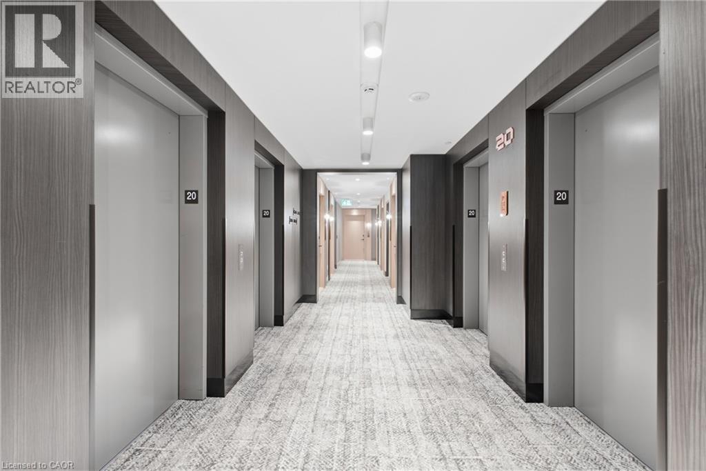 Hallway featuring wood-finish wall panels, recessed lighting, and textured carpet flooring - 60 Central Park Roadway Unit# 2010, Etobicoke, ON
