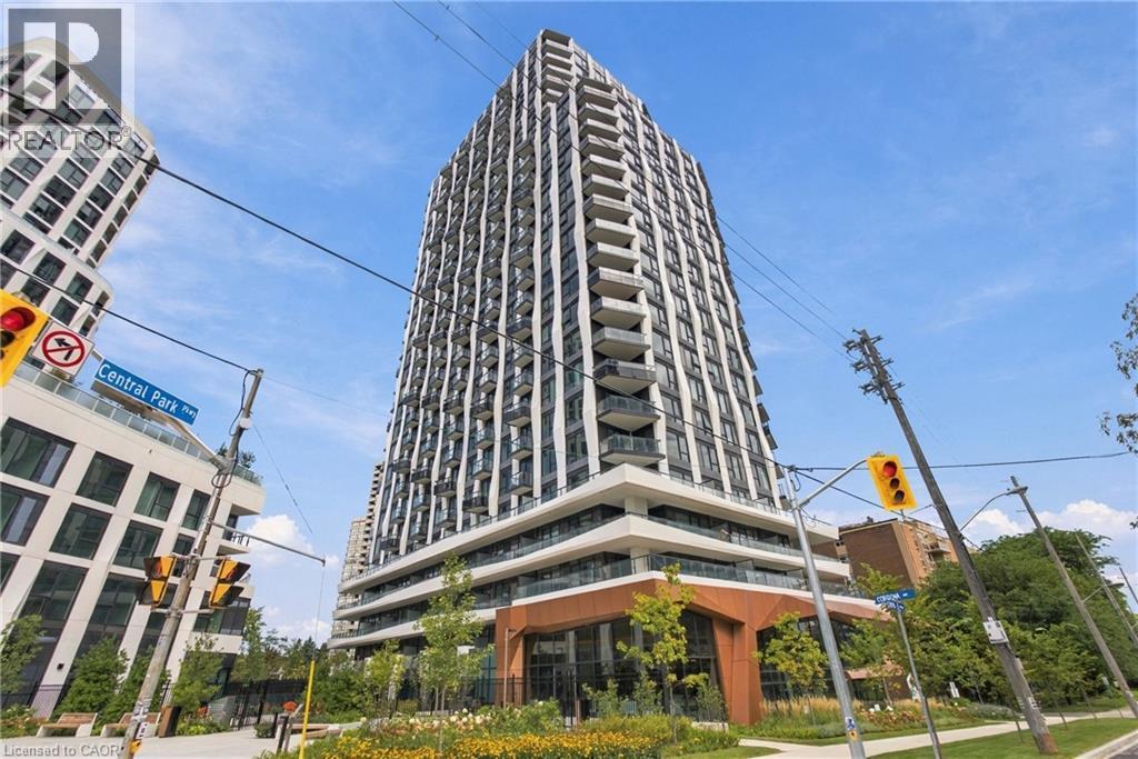 Modern high-rise residential building featuring multiple stories of balconies, expansive window walls, and a distinctive ground-level architectural design - 60 Central Park Roadway Unit# 2010, Etobicoke, ON