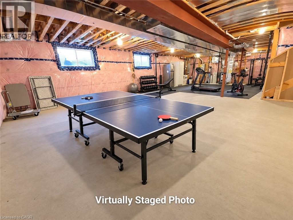 Finished lower level with exposed ceiling joists and structural beams, featuring recessed lighting and concrete flooring - 923 Eaglecrest Court, Kitchener, ON