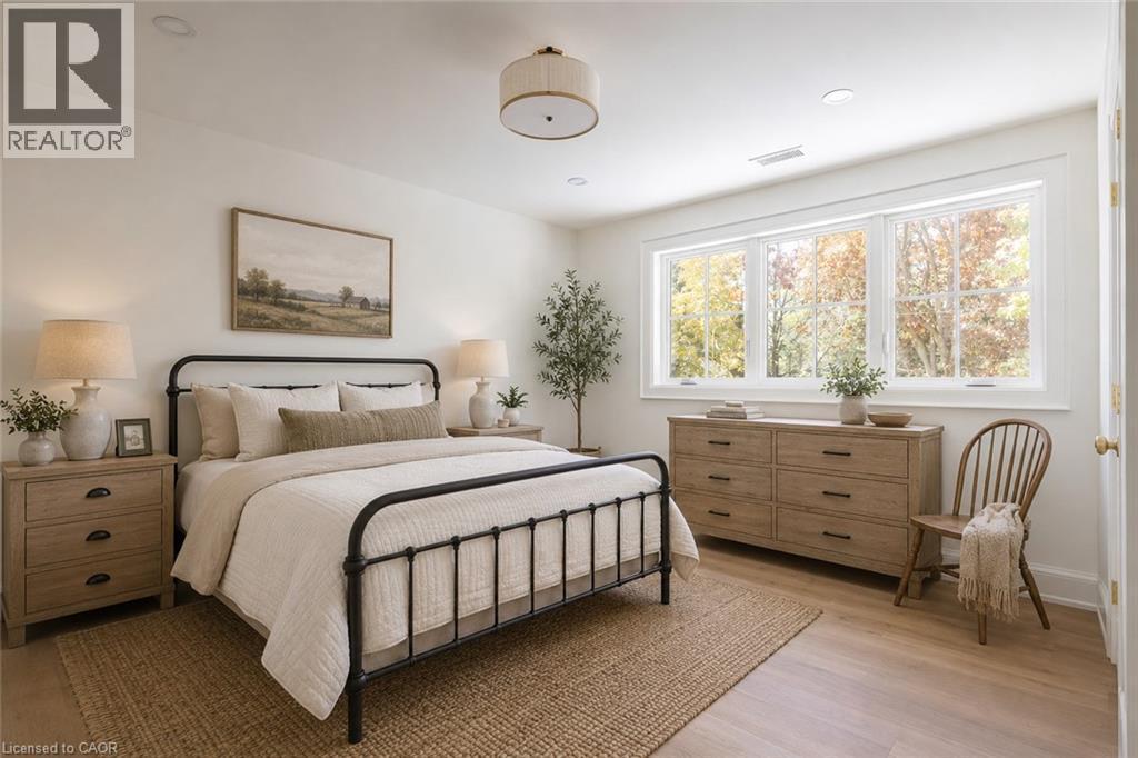 Expansive room featuring light wood-finish flooring, recessed lighting, and a large triple window with white trim - 130 Edgecliffe Place, Halton, ON