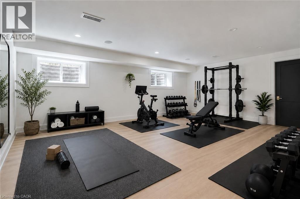 Dedicated fitness area featuring light wood-finish flooring, recessed lighting, and white walls - 130 Edgecliffe Place, Halton, ON