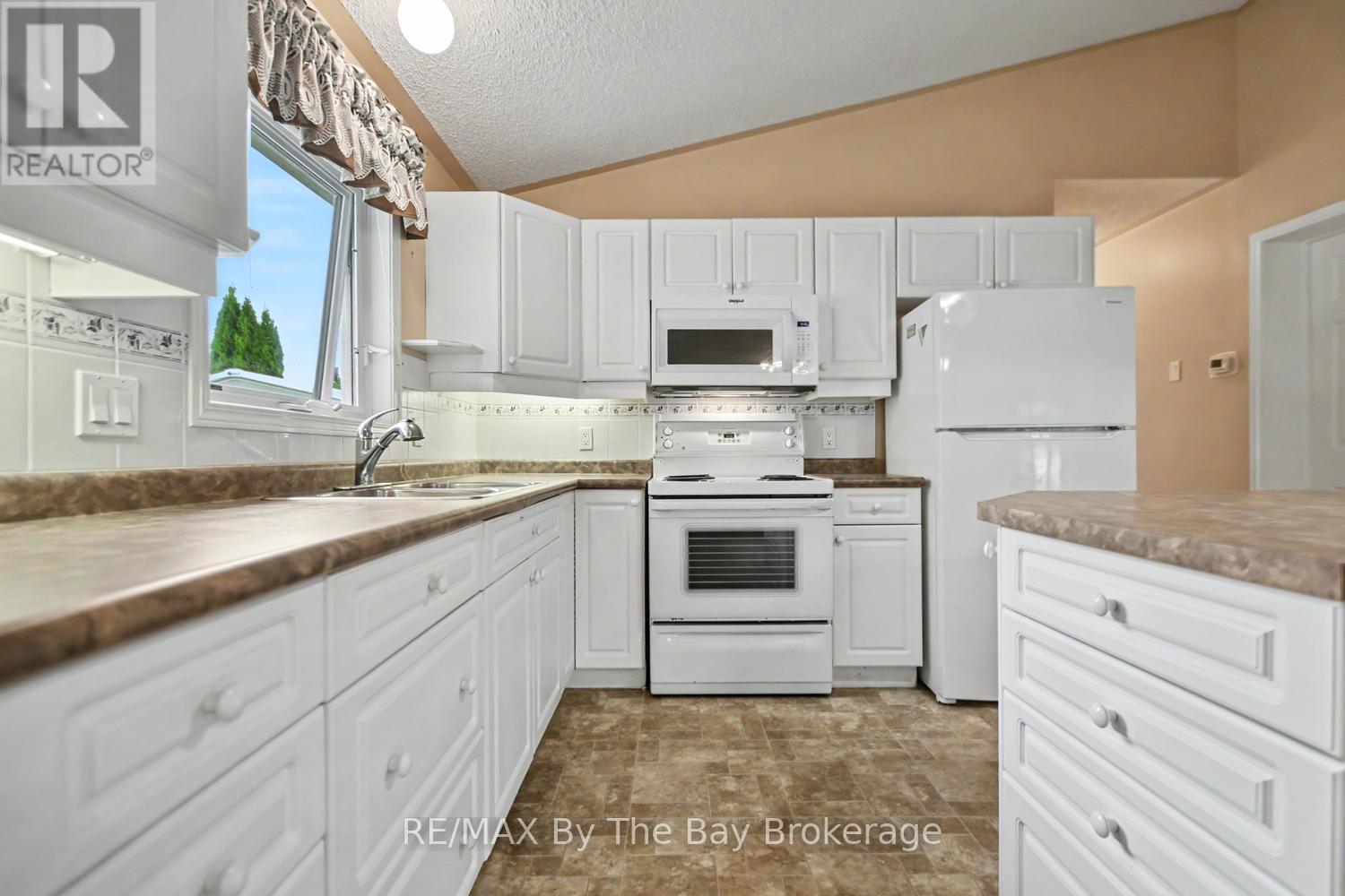 Kitchen Area with Sink Window - 30 St James Place, Wasaga Beach, ON