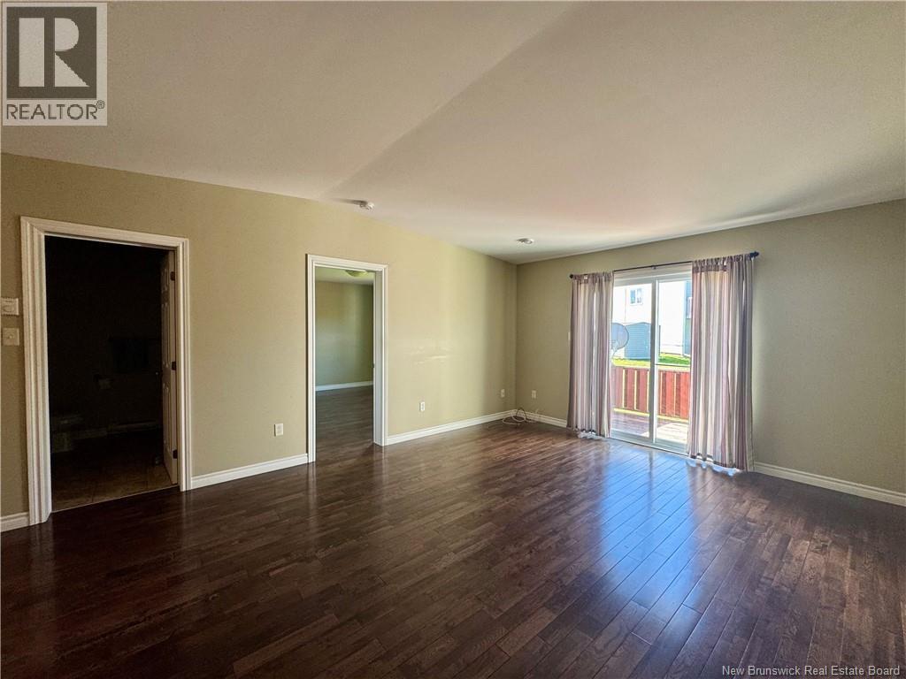 Living room with patio doors to back deck/yard - 26 Acorn Drive, Saint John, NB