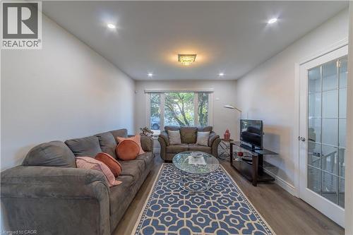 Recessed lighting, wood-finish flooring, white walls, and a glass-paneled interior door - 137 Nickolas Crescent, Cambridge, ON 