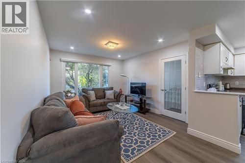 Recessed lighting, wood-finish flooring, white trim, and a glass-paneled door - 137 Nickolas Crescent, Cambridge, ON 