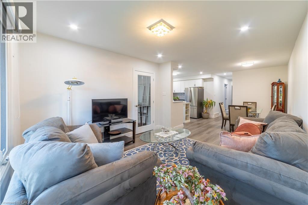 Recessed lighting, wood-finish flooring, white walls, and a glass-paneled door - 137 Nickolas Crescent, Cambridge, ON