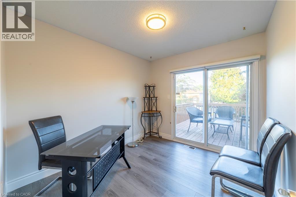 Wood-finish flooring with neutral wall tones and a ceiling-mounted light fixture - 137 Nickolas Crescent, Cambridge, ON