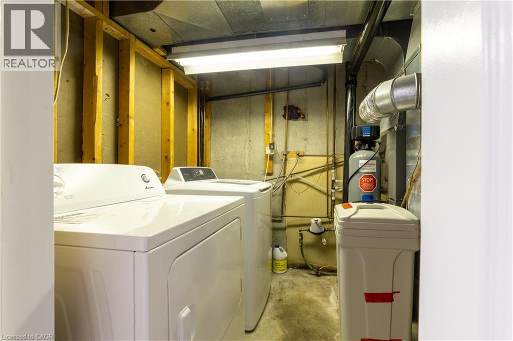 Utility area with concrete walls, exposed ceiling ductwork, and fluorescent lighting - 137 Nickolas Crescent, Cambridge, ON