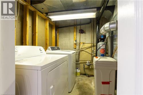 Utility area with concrete walls, exposed ceiling ductwork, and fluorescent lighting - 137 Nickolas Crescent, Cambridge, ON 