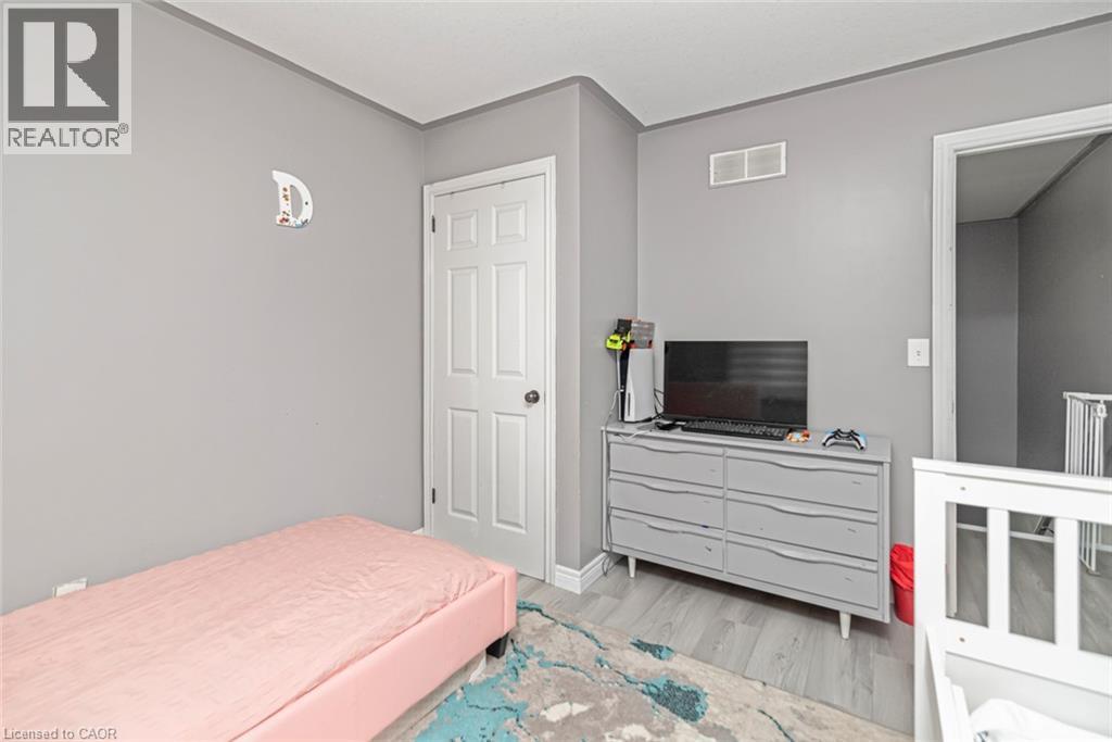 Gray walls with white trim, wood-finish flooring, and a white interior door - 42 Saturn Road, Port Colborne, ON