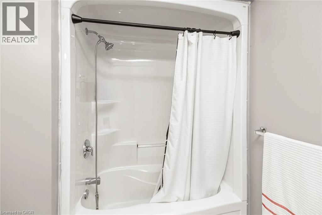 Integrated shower and bathtub unit with chrome fixtures - 42 Saturn Road, Port Colborne, ON