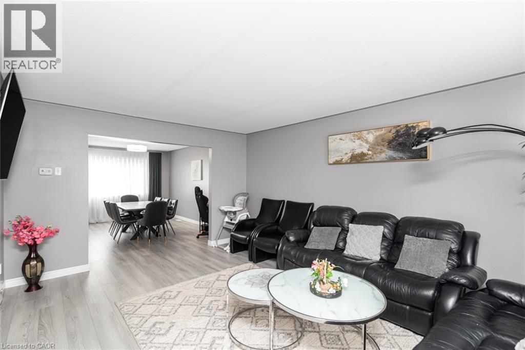 Open-concept living space featuring wood-finish flooring, recessed lighting, and a defined dining area - 42 Saturn Road, Port Colborne, ON