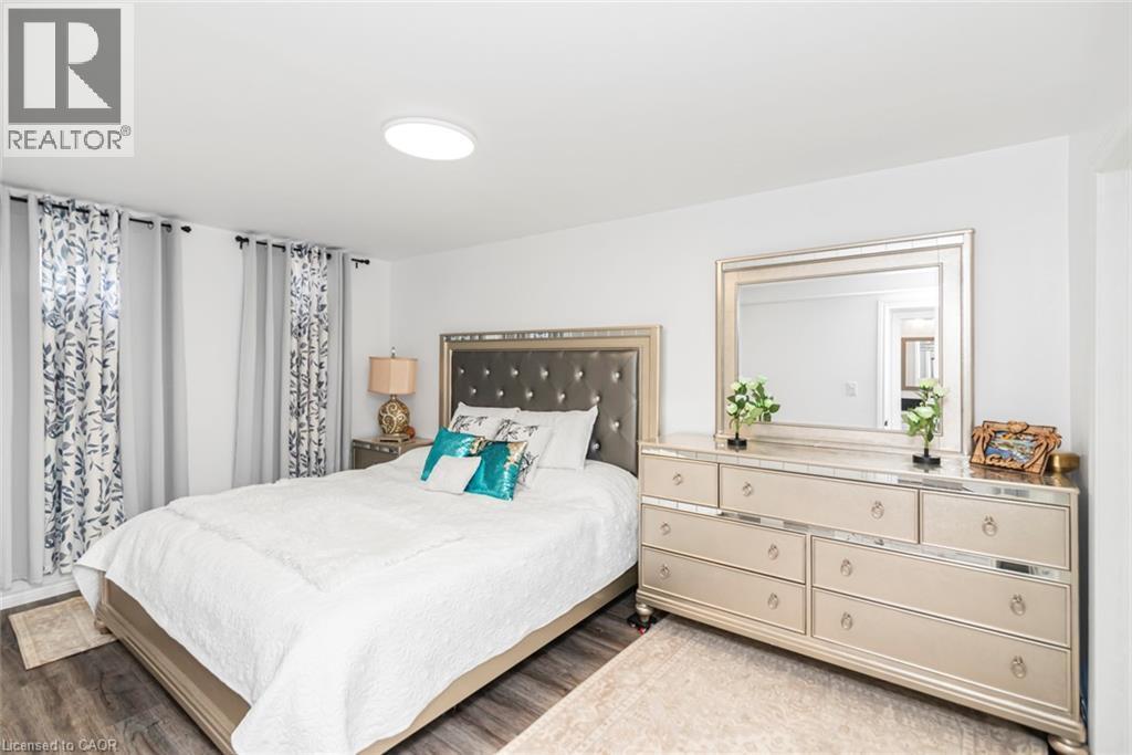 Wood-finish flooring, recessed ceiling light, and white walls - 42 Saturn Road, Port Colborne, ON