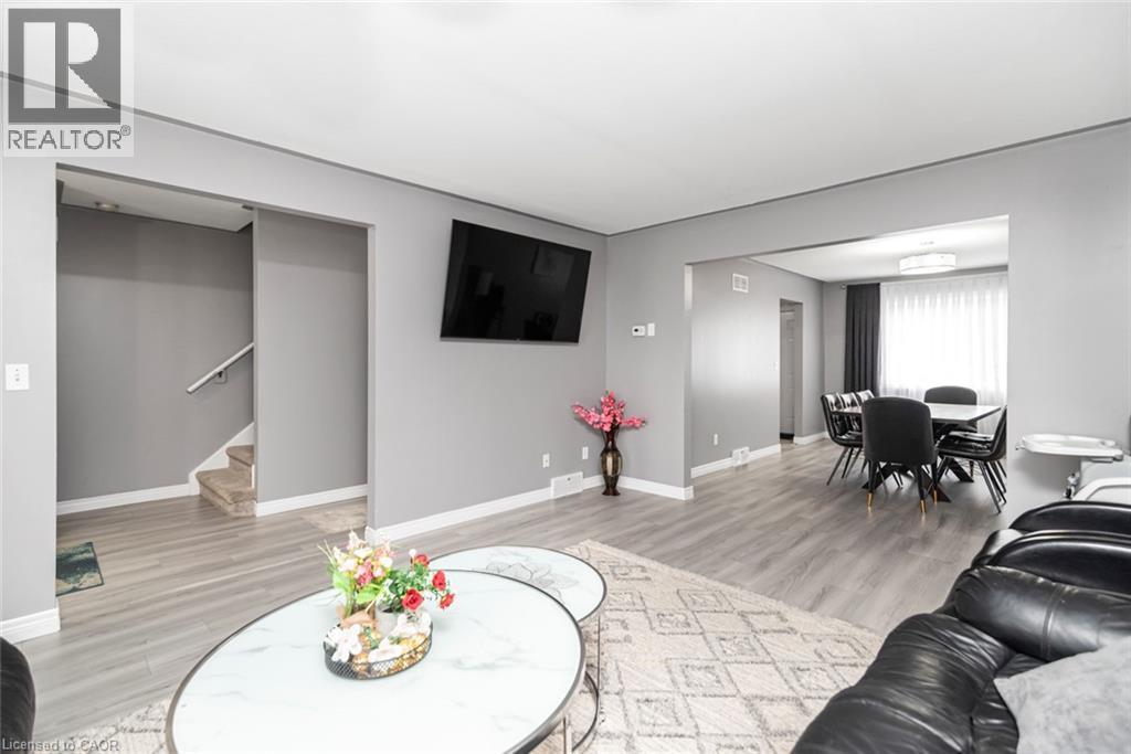 Gray wood-finish flooring throughout, complemented by light gray walls and white trim - 42 Saturn Road, Port Colborne, ON