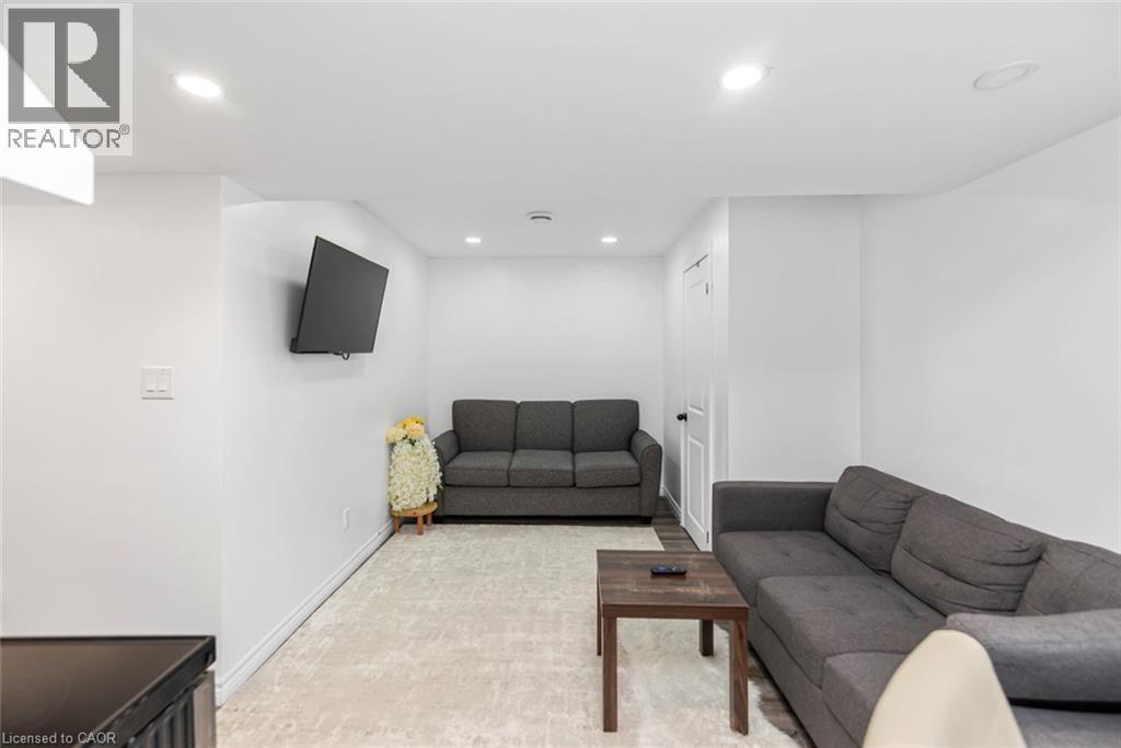 Recessed lighting, wood-finish flooring, white walls, and a white door with dark hardware - 42 Saturn Road, Port Colborne, ON