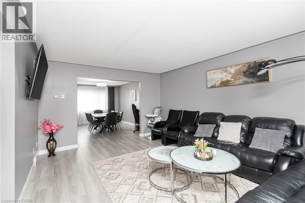 Wood-finish flooring throughout, with a framed opening leading to a dining area - 42 Saturn Road, Port Colborne, ON