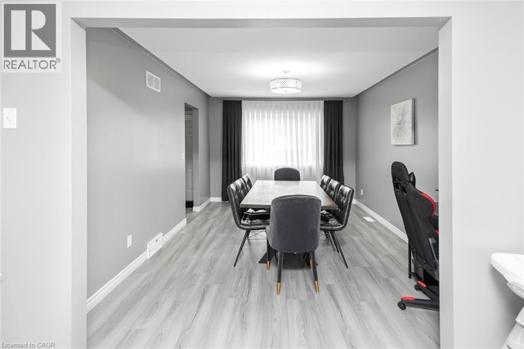Recessed lighting, light gray wood-finish flooring, white trim, and a contemporary ceiling fixture - 42 Saturn Road, Port Colborne, ON