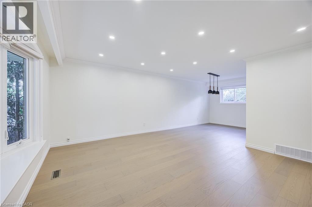 Recessed lighting, wood-finish flooring, bay window, crown molding, and pendant lighting fixture - 3148 Terraview Court, Burlington, ON