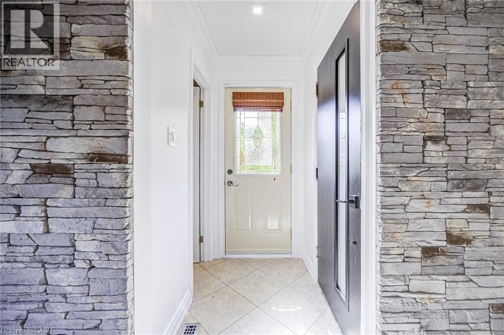 Stone veneer wall accents with crown molding detail - 3148 Terraview Court, Burlington, ON