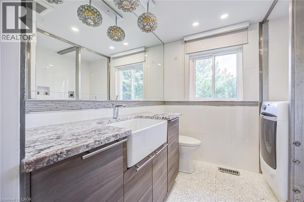 Double vanity with stone countertop and integrated farmhouse sink - 3148 Terraview Court, Burlington, ON