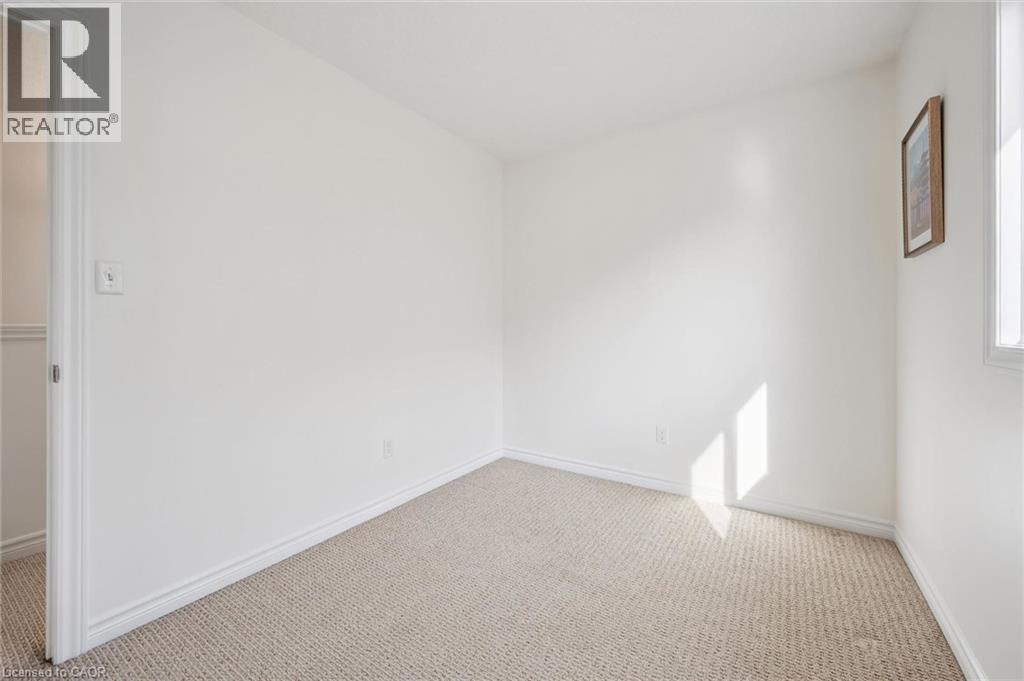 Neutral tone wall finishes, light-toned carpeting, and a window with natural light - 931 Glasgow Street Unit# 27B, Kitchener, ON