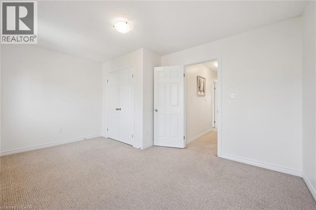 Neutral-toned carpeting, white walls, and a flush mount ceiling light fixture - 931 Glasgow Street Unit# 27B, Kitchener, ON