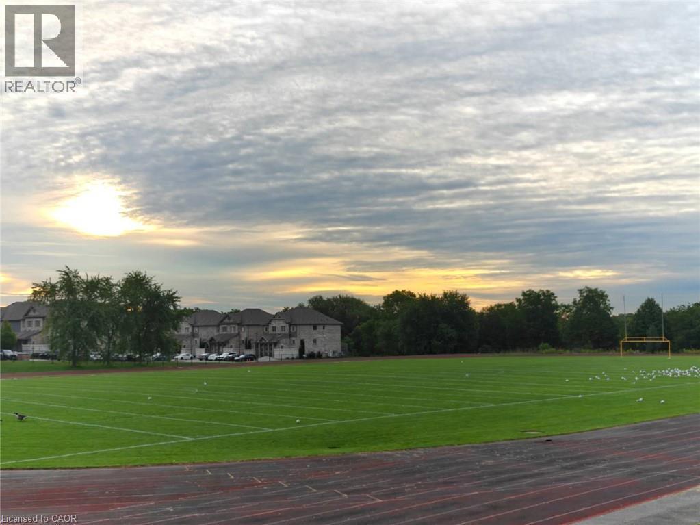 Expansive green field with striped markings and a running track alongside - 931 Glasgow Street Unit# 27B, Kitchener, ON