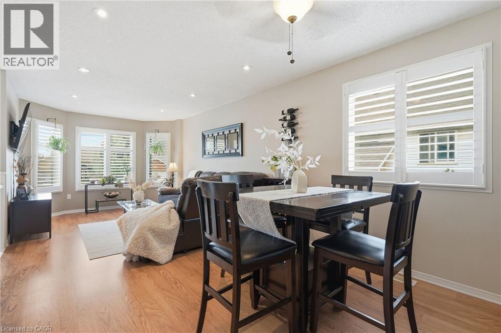 Recessed lighting, wood-finish flooring, bay window, plantation shutters, and a chandelier-style ceiling fixture - 94 Kent Road, Brantford, ON