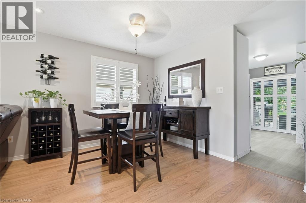 Wood-finish flooring throughout, with a window featuring white plantation shutters - 94 Kent Road, Brantford, ON