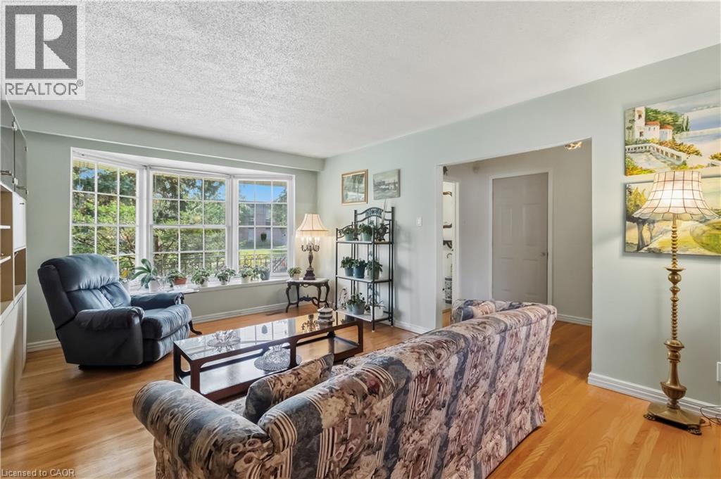 Bay window with multiple panes, built-in shelving, hardwood flooring, and light-toned wall finishes - 152 Hilda Avenue, North York, ON