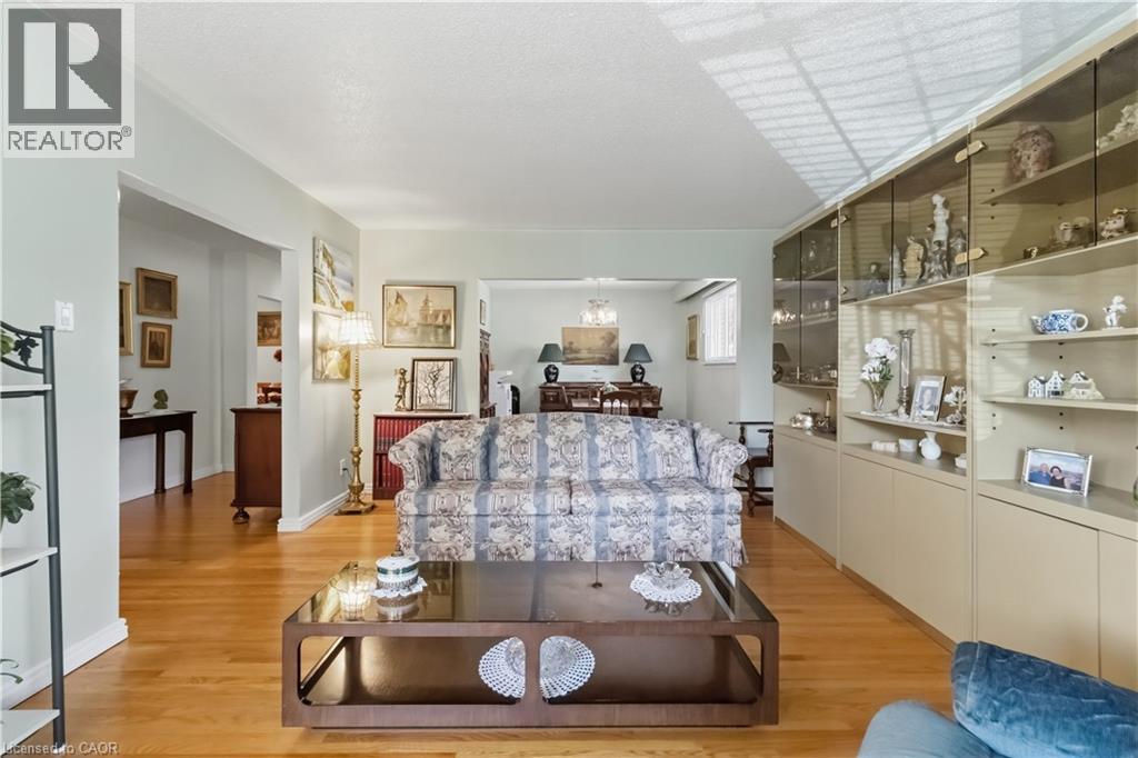 Hardwood flooring, recessed lighting, built-in display cabinetry with glass fronts, built-in lower cabinetry, and cased openings - 152 Hilda Avenue, North York, ON
