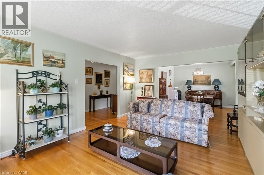 Hardwood flooring throughout, light-toned wall paint, and a built-in display cabinet with mirrored backing - 152 Hilda Avenue, North York, ON