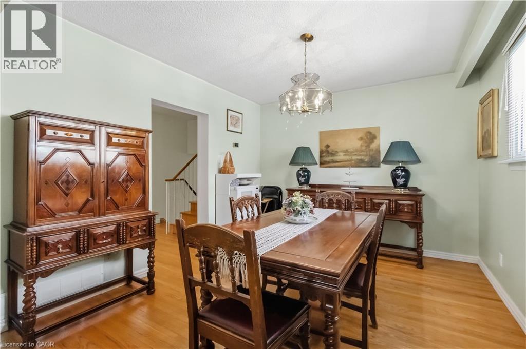 Hardwood flooring, light green wall finishes, and a decorative chandelier - 152 Hilda Avenue, North York, ON