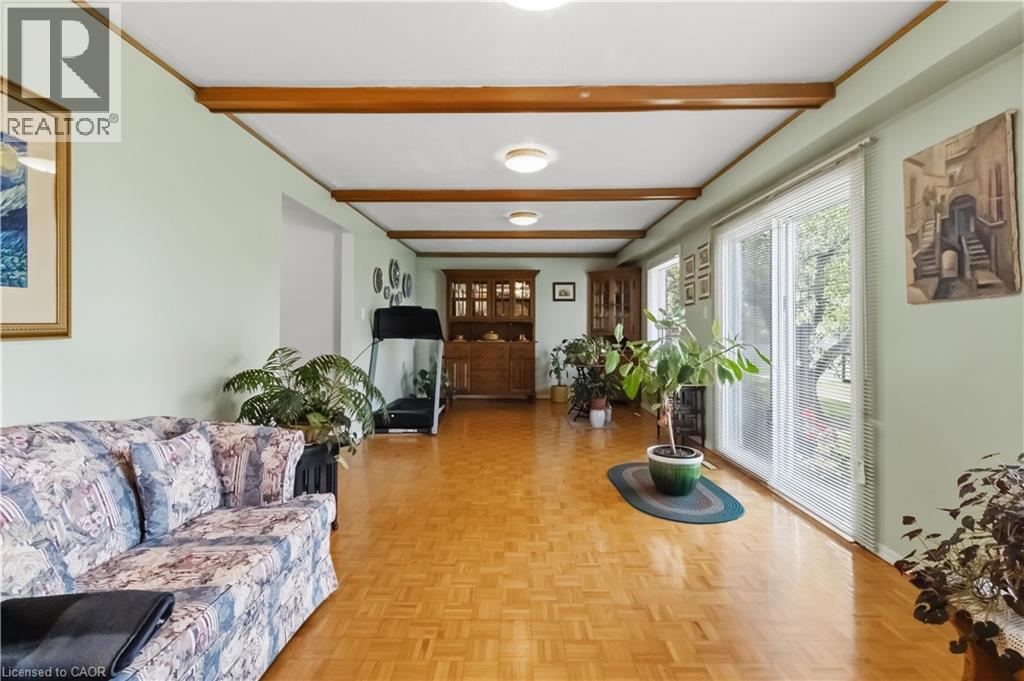 Hardwood parquet flooring, exposed ceiling beams, recessed lighting, and expansive glass sliding doors - 152 Hilda Avenue, North York, ON