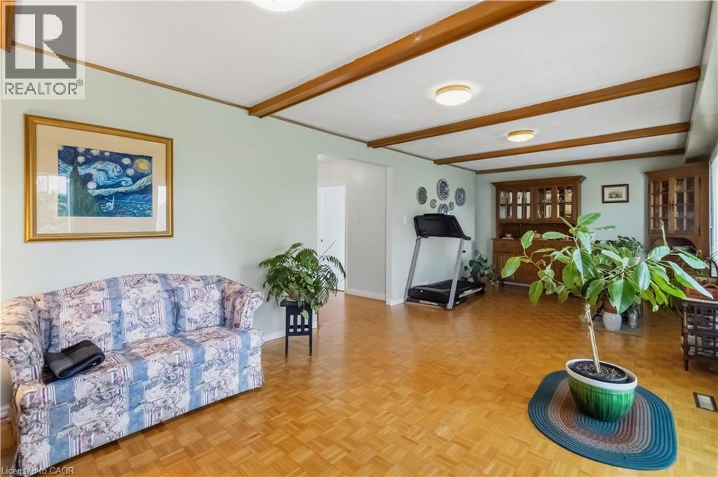 Wood-finish flooring with exposed ceiling beams and recessed lighting - 152 Hilda Avenue, North York, ON