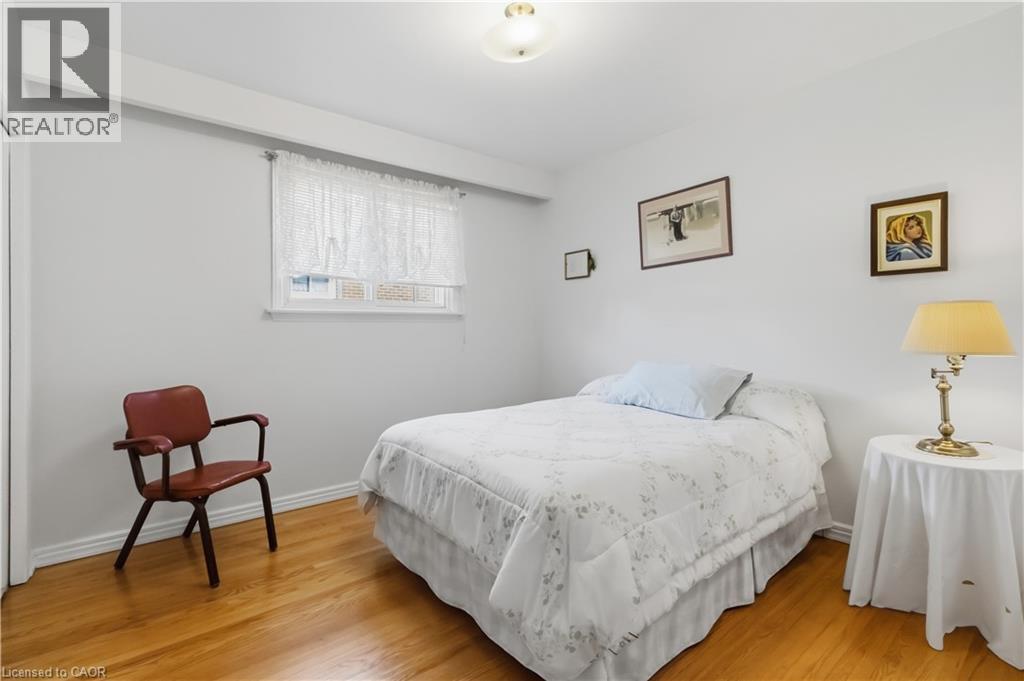 Wood-finish flooring, white walls, and a window with white trim - 152 Hilda Avenue, North York, ON
