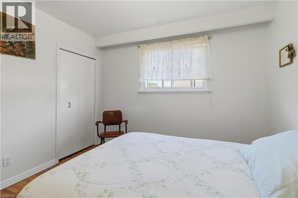 White walls with a single window, bi-fold closet doors, and wood-finish flooring - 152 Hilda Avenue, North York, ON