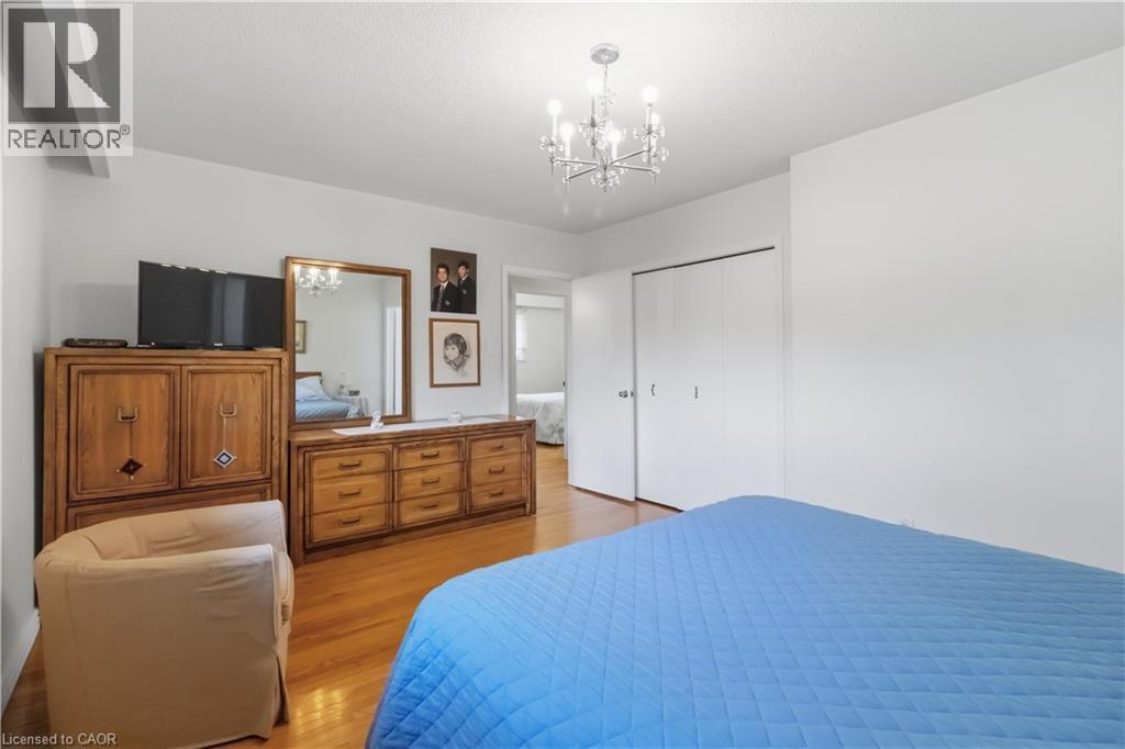 Hardwood flooring, crisp white walls, contemporary chandelier, and bi-fold closet doors - 152 Hilda Avenue, North York, ON