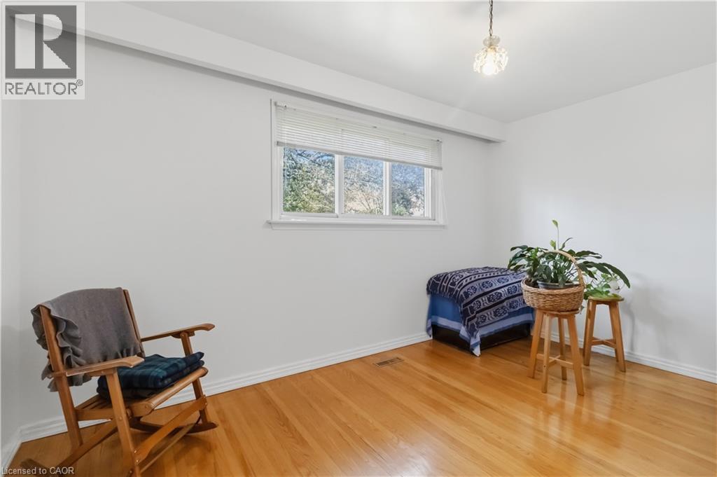 Wood-finish flooring, white walls, and a window with blinds provide a neutral canvas - 152 Hilda Avenue, North York, ON