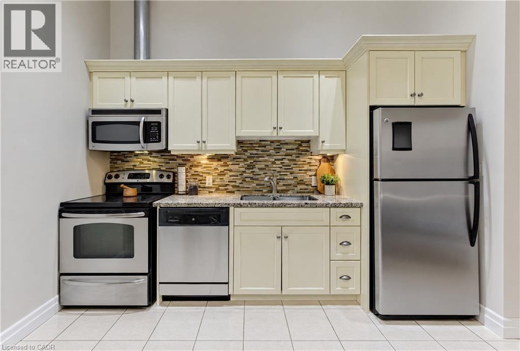 Stainless steel appliances, mosaic tile backsplash, light-colored cabinetry, granite-finish countertops, and tiled flooring - 25 Concession Street Unit# 110, Cambridge, ON