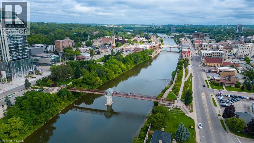 Riverfront urban setting with multiple bridges, mature trees, and diverse architectural styles - 25 Concession Street Unit# 110, Cambridge, ON